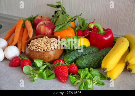 Healthy fruits and vegetables on kitchen desk Stock Photo