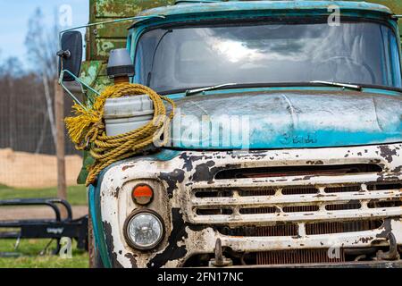 Gulbene, Latvia - May 02, 2021: vintage Soviet truck ZIL 130 in the village, close-up front details Stock Photo