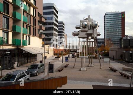 Stainless steel Trifot Sculpture, by David Černý. Czech Photo Centre,  Metronom Business Centre, Prague, Czechia  people unrecognisable in distance Stock Photo