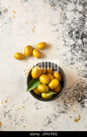 Raw kumquat on a white background Stock Photo