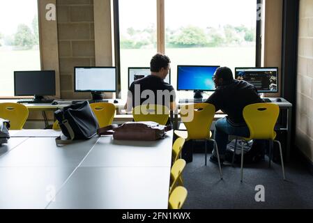 Sixth Form Students, Young people in education, two teenagers collaborating at screens, 2 young males in 6th Form working together Stock Photo