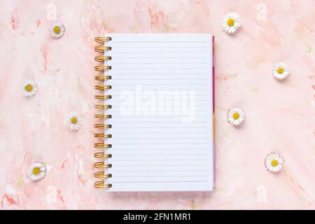 Woman To Do List and fresh spring daisy flowers Stock Photo