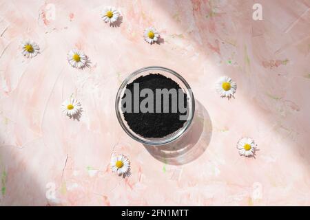 Black activated charcoal powder in glass bowl Stock Photo