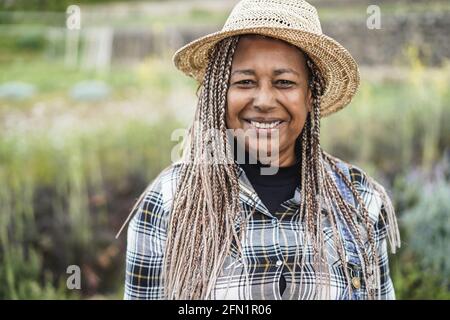 African farmer smiling on camera during harvest period - Focus on face Stock Photo