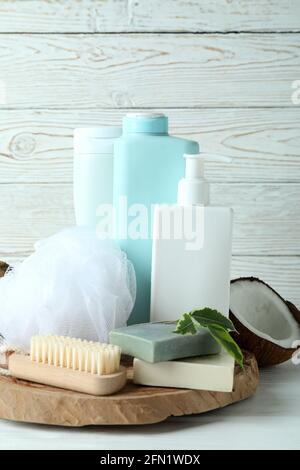 Bath cosmetics and coconut on white wooden background Stock Photo