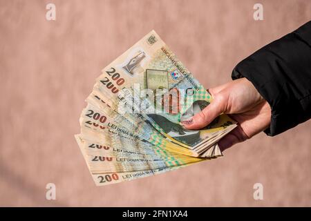 Selective focus on the detail of LEI banknotes. Counting or giving Romanian LEI banknotes. Stock Photo