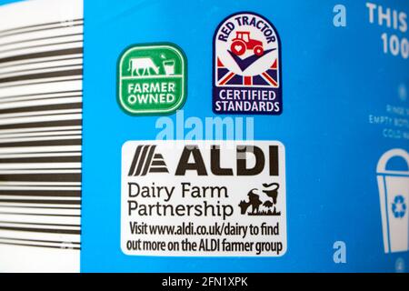 red tractor farmer owned and aldi dairy farm partnership labels on a bottle of british whole milk Stock Photo