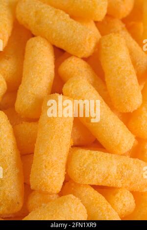 Cheese flavored puffed corn snacks in a bowl Stock Photo
