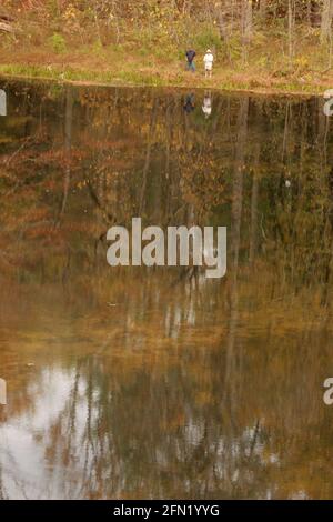 Men fishing on a lake in the Blue Ridge Mountains, VA, USA. Fall landscape. Stock Photo