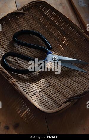 The scissors in the bamboo basket Stock Photo