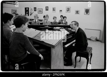 Kings College Chapel Choir December 1992 scanned 2021 Photographed in the lead up to the traditional Festival of Nine Carols in King’s College under the musical directorship of Stephen Cleobury,(seen here) later Sir Stephen. Sire Stephen died in 2019. Sir Stephen John Cleobury CBE  was an English organist and music director. He worked with the Choir of King's College, Cambridge, where he served as music director from 1982 to 2019 Stock Photo