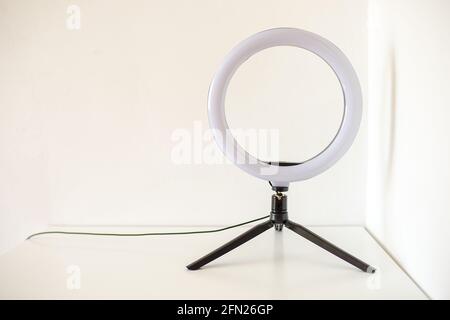 New ring lamp on tripod on white table. Stock Photo