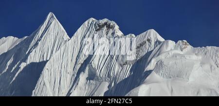 Mountain covered by glacier. Sharpe ridge. Scene in the Everest National Park Nepal. Stock Photo
