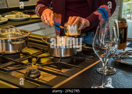 Onion melt is heated in the pot before being served with Maultaschen Stock Photo