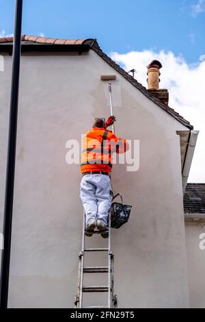 A Painter and Decorator Painting A House In Lewes, East Sussex, UK. Stock Photo