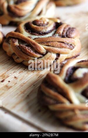 Cinnamon Buns Served on Wooden Board for Breakfast. Bakery Pastry. Stock Photo