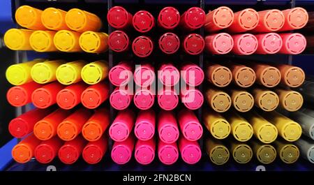 Multi colors highlighter pen line up in slots. A large number of multi-colored markers Stock Photo