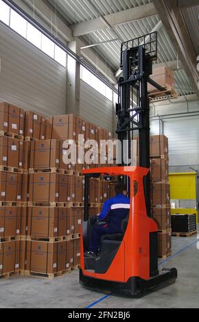 Ordering goods with forklift in warehouse Stock Photo