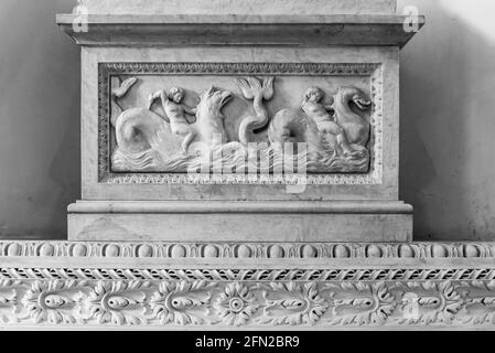 Black and white photo of mythological scene carved on an ancient marble piece Stock Photo