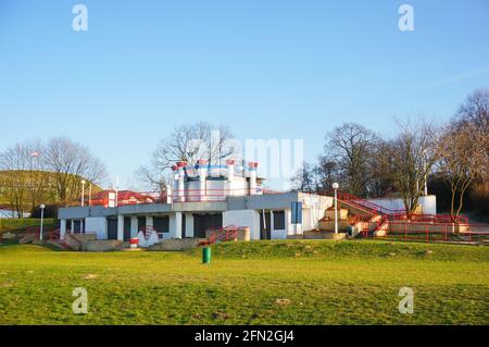 POZNAN, POLAND - Apr 11, 2016: Grass field and a building with bathrooms on the Malta park Stock Photo