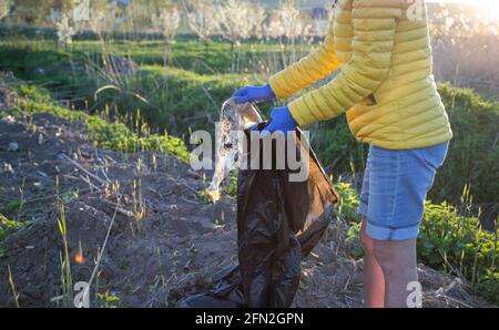 volunteer collecting plastic garbage Earth day Stock Photo