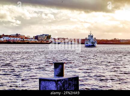 A ferry boat crosses the River Tyne from South Shields to North Shields in the north of England Stock Photo
