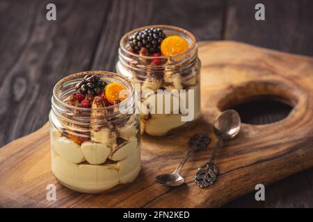 Homemade tiramisu dessert in glass jars. Stock Photo