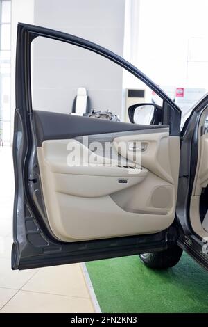 Russia, Izhevsk - February 19, 2021: Nissan showroom. Interior of new Murano car with opened driver door. Famous world brand. Modern transportation. Stock Photo