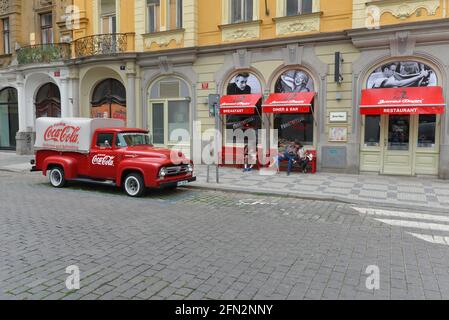 Prague, Czech Republic : Vintage truck with coat of arms of the Coca Cola parked in front of James Dean cafe old town center Stock Photo