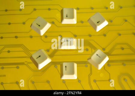 Keyboard arrow keys surround the key ESC on yellow electric Stock Photo