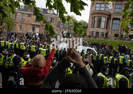 Glasgow, UK. 13th May, 2021. A demonstration in Kenmure Street in the Pollokshields area of the city, to protest against the detention of two immigrant men by Immigration Detention officers, was met by a heavy police presence as protestors blocked roads preventing the Immigration van from leaving. After hours of negotiation the immigrants were released without charge. Photo Credit: jeremy sutton-hibbert/Alamy Live News Stock Photo