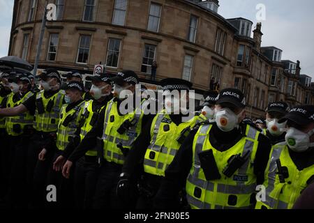 Glasgow, UK. 13th May, 2021. A demonstration in Kenmure Street in the Pollokshields area of the city, to protest against the detention of two immigrant men by Immigration Detention officers, was met by a heavy police presence as protestors blocked roads preventing the Immigration van from leaving. After hours of negotiation the immigrants were released without charge. Photo Credit: jeremy sutton-hibbert/Alamy Live News Stock Photo