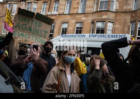 Glasgow, UK. 13th May, 2021. A demonstration in Kenmure Street in the Pollokshields area of the city, to protest against the detention of two immigrant men by Immigration Detention officers, was met by a heavy police presence as protestors blocked roads preventing the Immigration van from leaving. After hours of negotiation the immigrants were released without charge. Photo Credit: jeremy sutton-hibbert/Alamy Live News Stock Photo