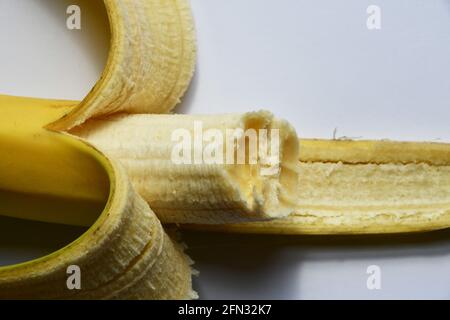 Half eaten Banana ,partially pealed, ripe yellow,healthy nutricious snack. Stock Photo