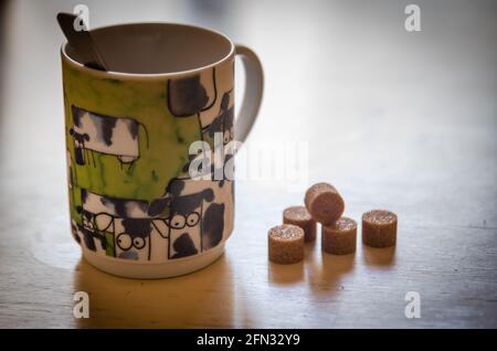 the fancy coffee cup and its sugar cubes Stock Photo