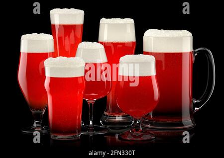 Set of fresh stout beer glasses with bubble froth isolated on black background. Stock Photo