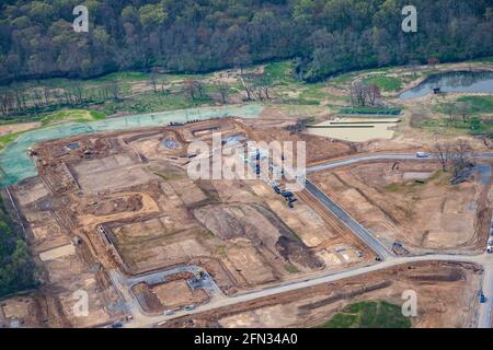 Aerial view of a residential construction site with tower cranes and ...