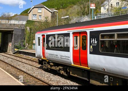 Ynysowen, Merthyr Tydfil,  Wales - May 2021: Pssenger train operated by Transport for Wales about to leave Ynysowen railway station in Merthyr Vale. Stock Photo