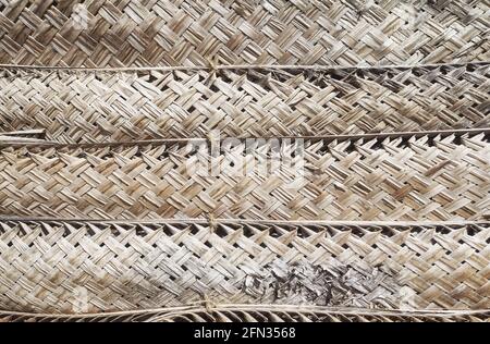 Dried woven palm leaf wall, natural background. Stock Photo