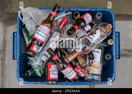 Glass recycling box full of empty bottles in the New Town, Edinburgh, Scotland, UK. Stock Photo