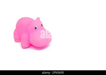Pink colored plastic hippopotamus toy isolated on white background. Stock Photo
