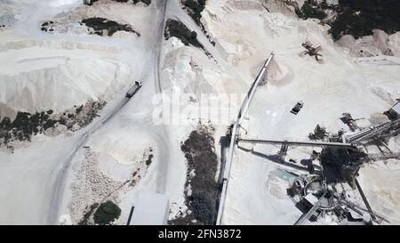 large Quarry withe Stone sorting conveyor belts and an open pit mine.  Stock Photo