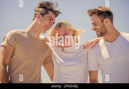 Friendship relations. People outdoors. Happy woman and two men. Member friendship wishes to enter into romantic relationship. Friendship love. Friend Stock Photo