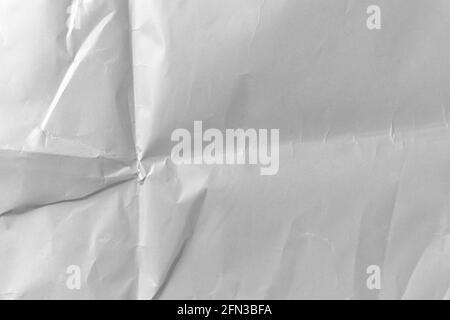 Abstract paper wrinkled dusty folded background from white crumpled blank page Stock Photo