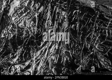 Black crumpled wrinkled plastic abstract grunge background Stock Photo