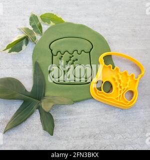 cookie cutter for cutting Easter biscuits on dough for kids Stock Photo