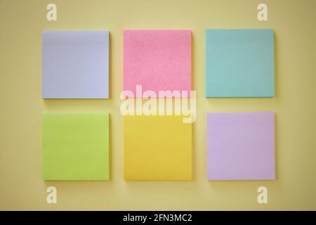 Top View or Flat Lay 6 Color Stick Note or Note Pad as Blue,Pink,Turquoise,Green,Yellow,Purple on Office Desk or Office Table. Office Supplies on Past Stock Photo