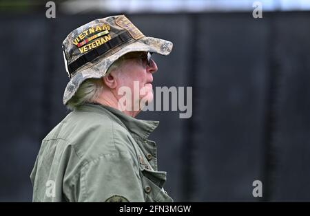 Tunkhannock, United States. 13th May, 2021. A Vietnam War Veteran stands at the Wall that heals, Vietnam War memorial traveling replica.The Wall That Heals is a three-quarter scale replica of the Vietnam Veterans Memorial in Washington, DC, the wall travels around the country and is set up and displayed for 24 hours a day while it is in place. Credit: SOPA Images Limited/Alamy Live News Stock Photo