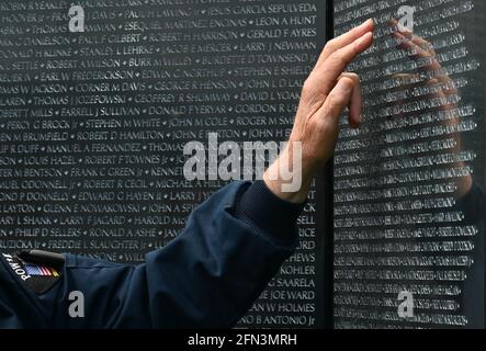 Tunkhannock, United States. 13th May, 2021. A man touches the Wall that Heals while looking for a name near the apex of the memorial.The Wall That Heals is a three-quarter scale replica of the Vietnam Veterans Memorial in Washington, DC, the wall travels around the country and is set up and displayed for 24 hours a day while it is in place. (Photo by Aimee Dilger/SOPA Images/Sipa USA) Credit: Sipa USA/Alamy Live News Stock Photo