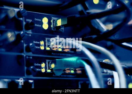 Network connection technology with network switch router, ethernet cables and status LED to show working status of data center equipment in mobile tel Stock Photo
